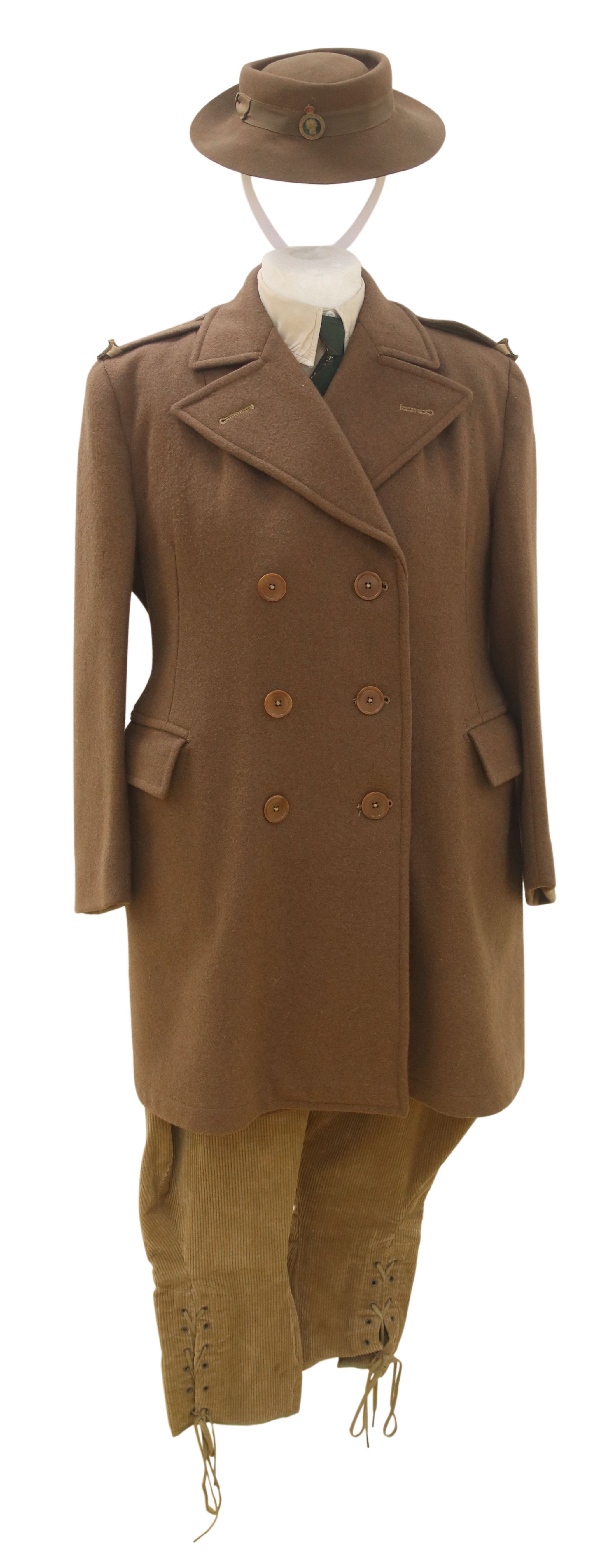 Colour photograph of a mannequin wearing the Women' Land Army brown felt hat, a brown wool double-breasted overcoat, and dark beige corduroy breeches.