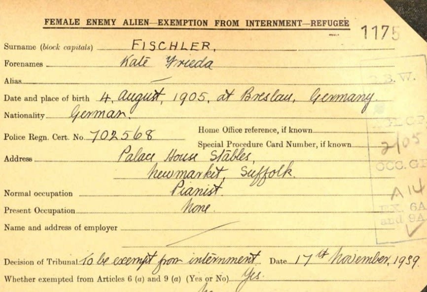Close up view of part of a historic record card for Kate Fischler. It gives her date of birth as 4th August 1905 at Breslau, Germany, and her nationality as German. Her Policy Registration Certificate Number is 702568, and her address was Palace House Stables, Newmarket, Suffolk. Her normal occupation was pianist, and her present occupation was 'none'.