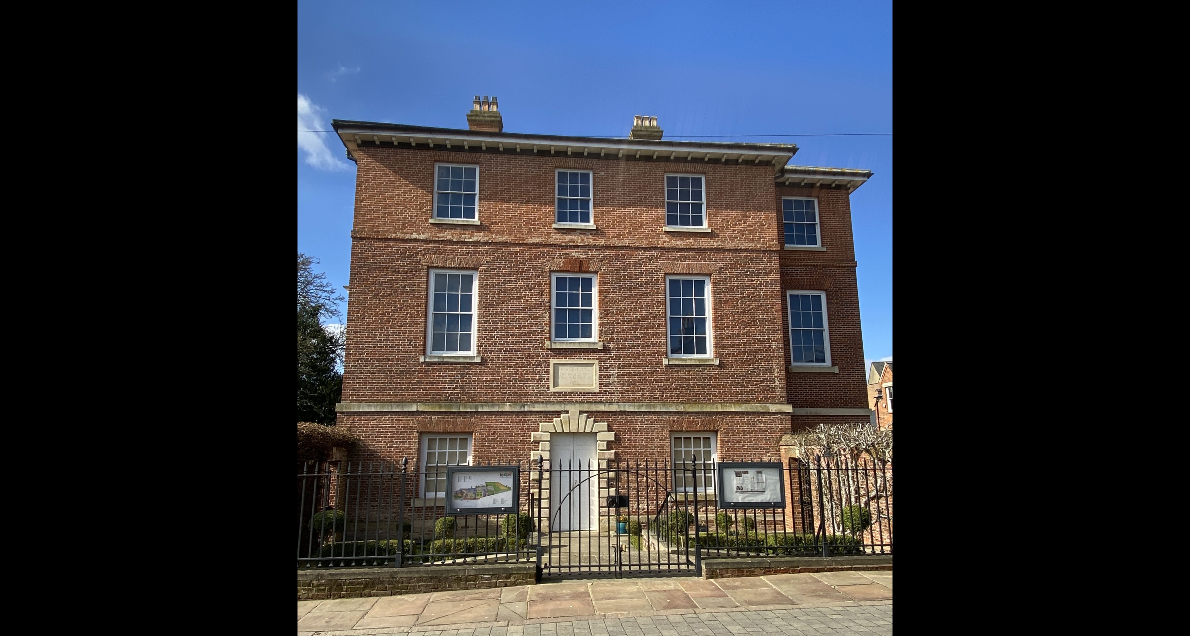 Modern colour photograph of the same building today. We can see now it is of red brick. Two main changes have occurred - the large roof dormer is gone, and the entrance door has been moved to the ground floor, and the flight of stone steps is gone.